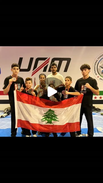 Arab Muay Thai Championship, Benghazi — junior athletes and coach with the Lebanese flag.